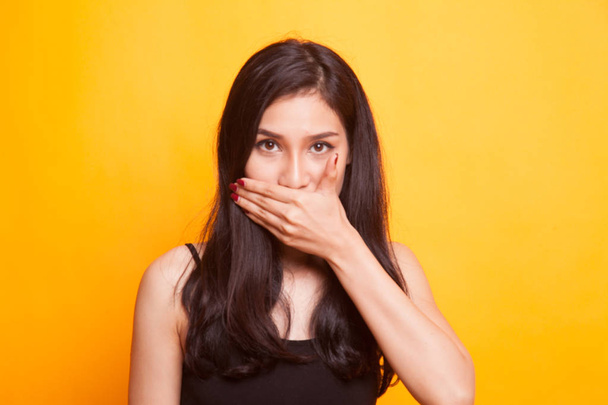 Young Asian woman angry and point to camera on yellow background - Photo, Image