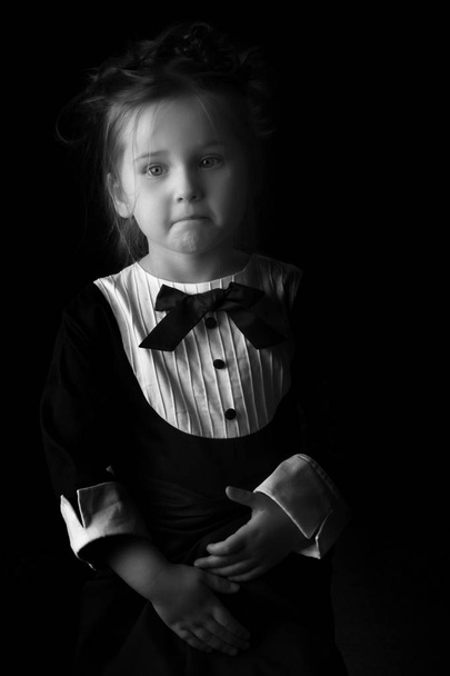 Little girl on a black background - Photo, Image