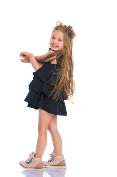 A cheerful little girl is dancing. - Fotó, kép