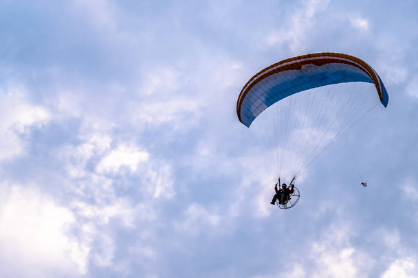 Paraglider flying with paramotor during sunset - Foto, Imagem