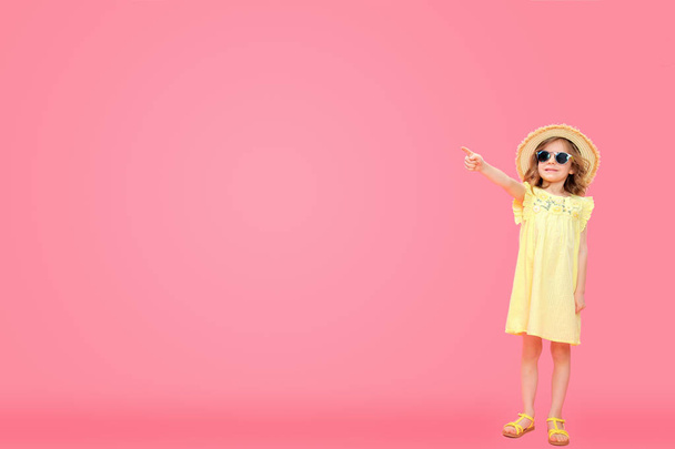 Little girl in dress pointing away - Фото, зображення