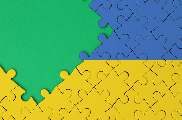 Flaga Ukrainy jest przedstawiany na wypełniony puzzli z bezpłatny egzemplarz zielonej przestrzeni po lewej stronie. - Zdjęcie, obraz