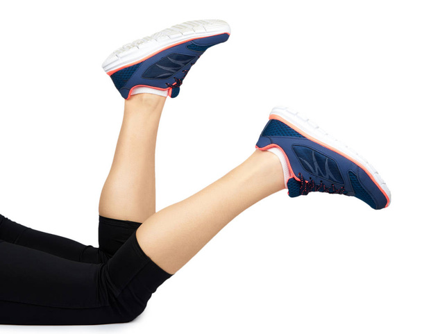 Fit female leg in sport shoe isolated on white background. - Zdjęcie, obraz