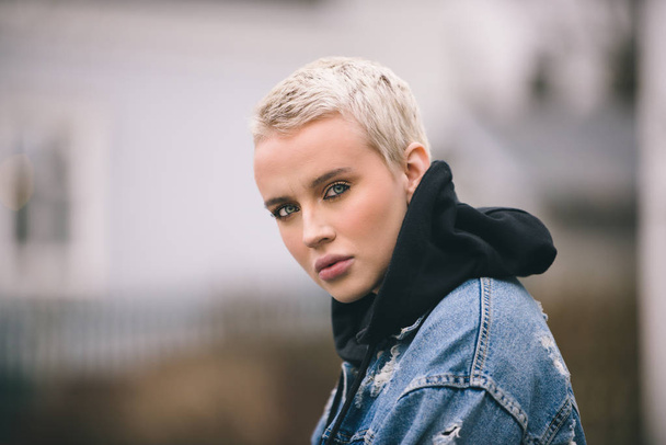 Portrait of young beautiful woman with short hairs - Influencer posing for a fashion advertising campaign - Fotó, kép