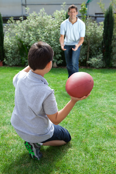 Father and son playing american football - Photo, image