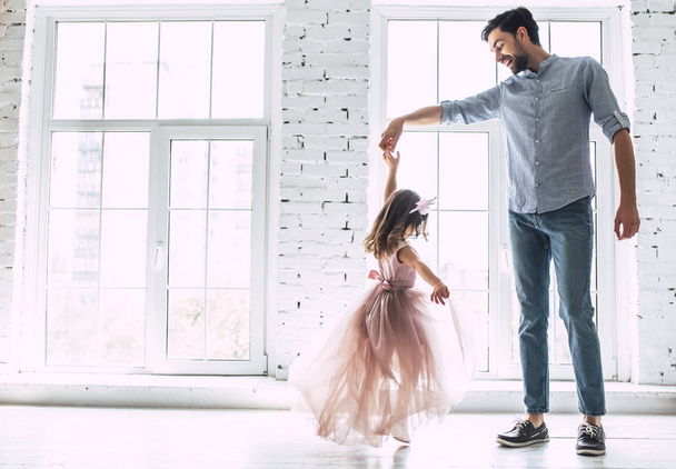 I love you, dad! Handsome young man is dancing at home with his little cute girl. Happy Father's Day! - Fotoğraf, Görsel