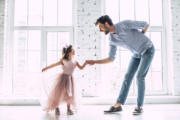 I love you, dad! Handsome young man is dancing at home with his little cute girl. Happy Father's Day! - Foto, imagen