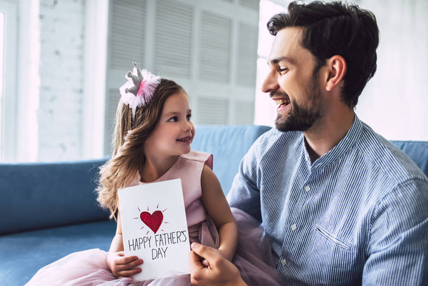 I love you, dad! Handsome young man at home with his little cute girl. Happy Father's Day! - Zdjęcie, obraz
