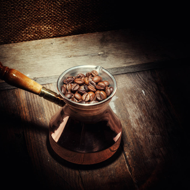 coffee beans in copper coffee turk on wooden background - Fotoğraf, Görsel