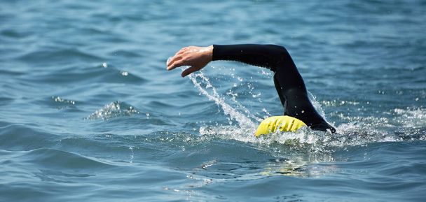 Triathlon long distance swimming, people in wetsuit swimming at triathlon - Fotografie, Obrázek