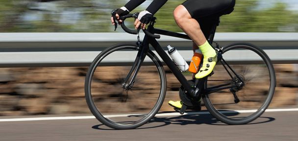 Motion blur of a bike race with the bicycle and rider at high speed - Photo, Image