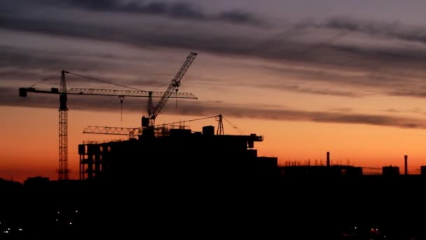 Bouw van hoogbouw bouwen tegen op de achtergrond van de zonsopgang, time-lapse  - Video