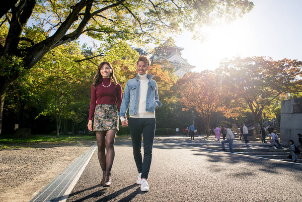 Young japanese couple dating outdoors - 写真・画像
