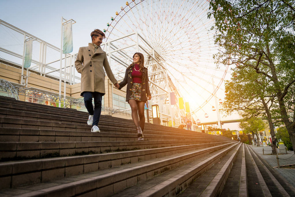 Young japanese couple dating outdoors - 写真・画像