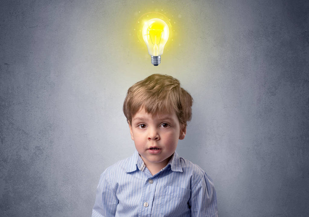 Little boy mull over with bulb above his head - Photo, Image