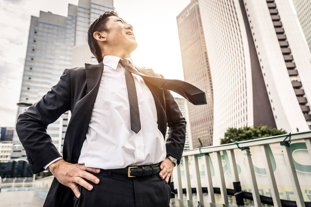 Japanese businessman walking outdoors - Asian man with elegant suit - Fotó, kép