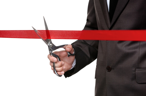 A man cutting a scarlet satin ribbon - 写真・画像