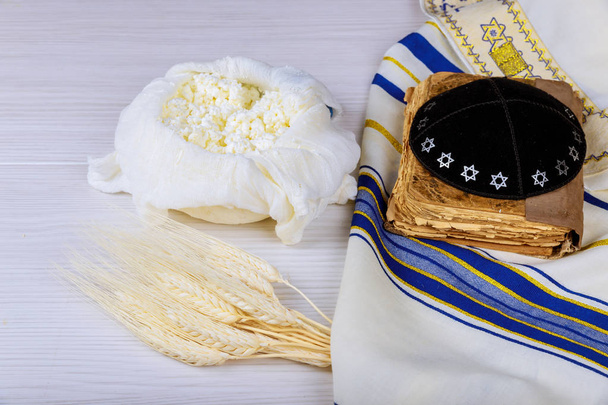 Cheese and Shofar, dairy products on white wooden background. Jewish holiday Shavuot concept. View from above - Photo, Image