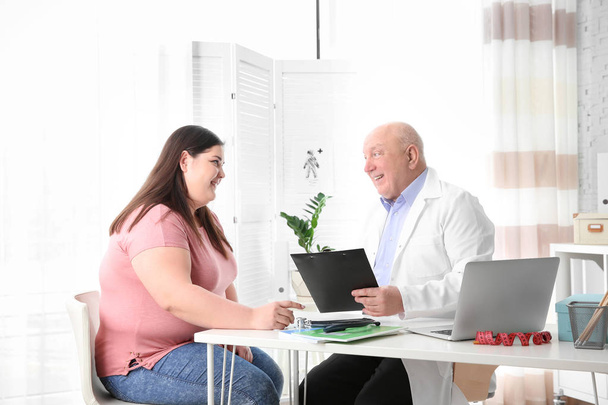 Overweight woman having consultation at doctor's office - Foto, Imagem