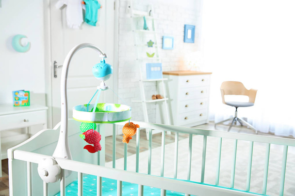 Cozy crib in light baby room interior - Foto, imagen