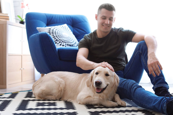 Portrait of owner with his friendly dog at home - Foto, Imagem