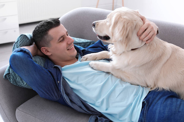 Portrait of owner with his friendly dog at home - Foto, imagen