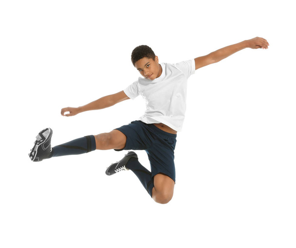 Teenage African-American boy playing football on white background - Фото, изображение