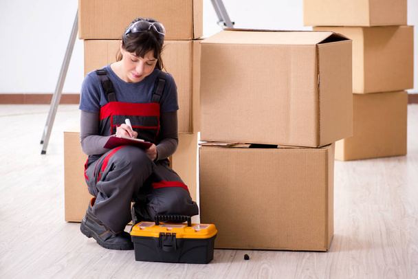 Woman contractor moving boxes in relocation concept - Photo, Image