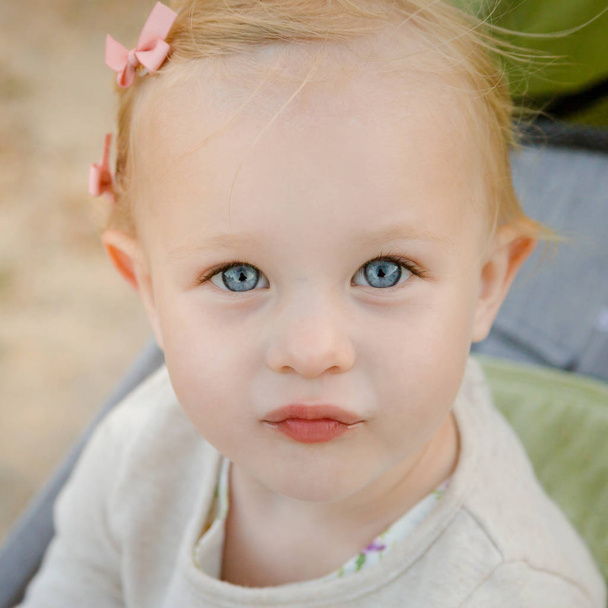 Εσωτερικη πορτρέτο του αξιολάτρευτο κοριτσάκι με μεγάλα μπλε μάτια. - Φωτογραφία, εικόνα