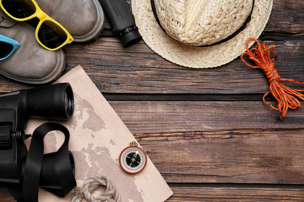Flat lay composition with camping equipment on wooden background - Zdjęcie, obraz