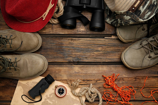 Flat lay composition with camping equipment on wooden background - Photo, image