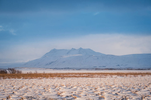 Dramatic icelandic landscape with snow covered mountains. Cold winter day in Iceland. - Fotó, kép