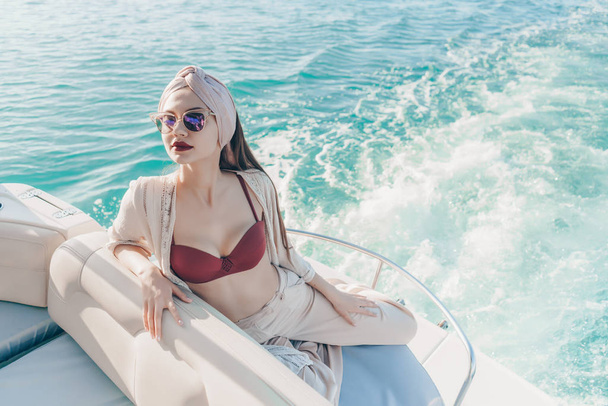 luxurious rich women in sunglasses are resting and relaxing on their white yacht, sea voyage - Φωτογραφία, εικόνα