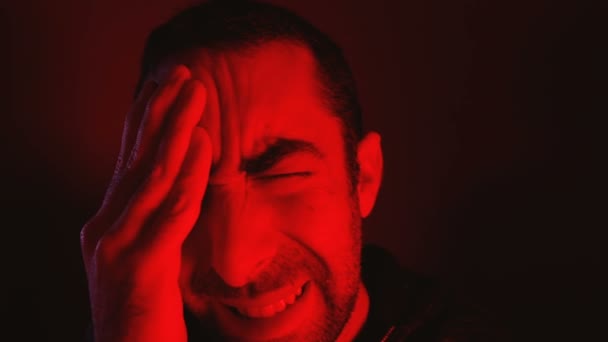 Man met gesloten ogen wrijft zijn kop en het lijden van pijn - Video