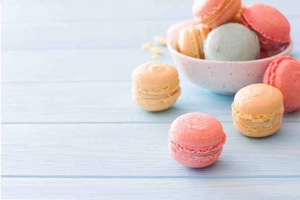 Assorment of colorful homemade  macarons on blue wood background. Close up. Selective focus - Фото, зображення