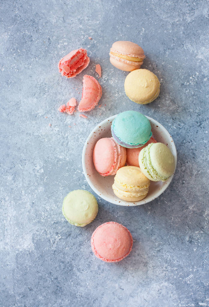 Assortment of colorful homemade  macarons on blue stone background. Top view.  - Fotoğraf, Görsel