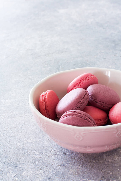 Colorful French or Italian macaroons on grey stone background. Close up. Selective focus - Foto, immagini