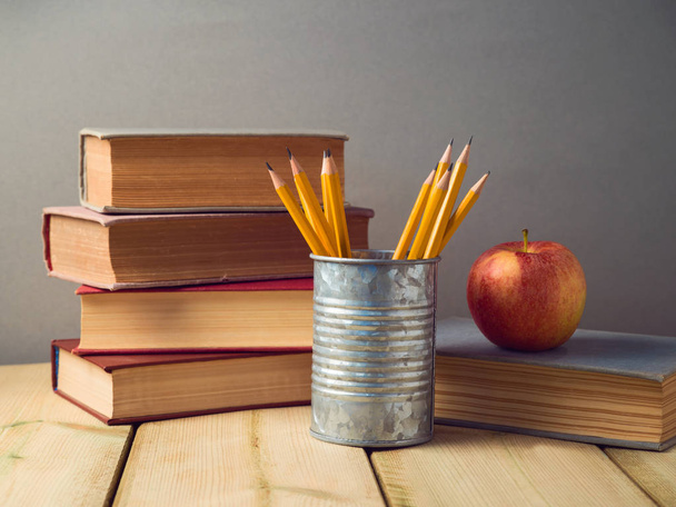 Back to school concept with pencils, apple and old books on wooden table - Φωτογραφία, εικόνα