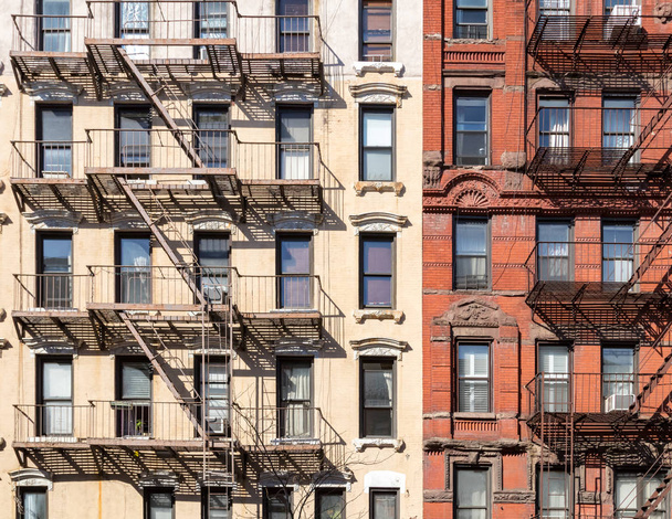 Wall of windows and fire escapes on old historic buildings in New York City - Photo, image