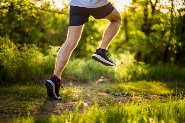 Athletic young man running in nature. Healthy lifestyle - Photo, Image