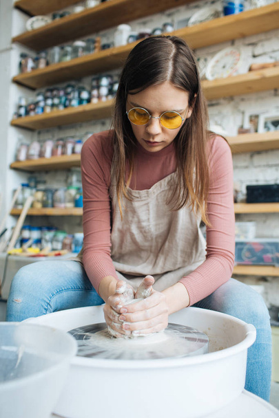 Handcrafted on a potter's wheel,Hands make clay from various items for home and sale in the store and at the exhibition, ceramic items are made in hand, beautiful girl makes products from clay - Foto, immagini