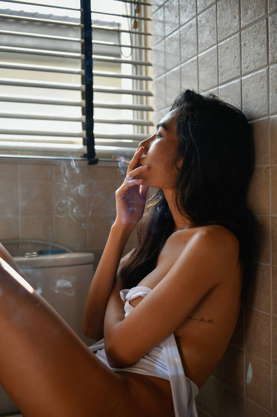 Koncept kouření. Sexy ženy se kouření v místnosti. Sexy ženy jsou relaxační uzením. Krásné ženy mají svůdné kouzlo. - Fotografie, Obrázek
