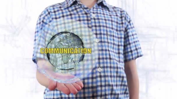 Genç adam bir hologram Dünya gezegeninin ve metin Communiccation gösterir - Video, Çekim