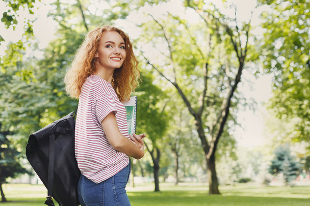 Student girl with books in park outdoors - Φωτογραφία, εικόνα
