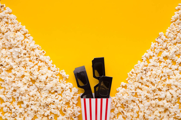 3D glasses and popcorn on yellow background - Photo, Image