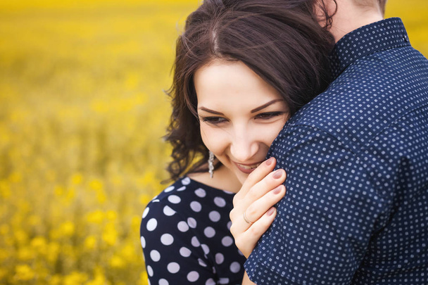 woman and guy hugging on yellow meadow - Fotó, kép