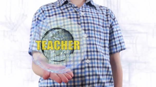 Young man shows a hologram of the planet Earth and text Teacher - Footage, Video