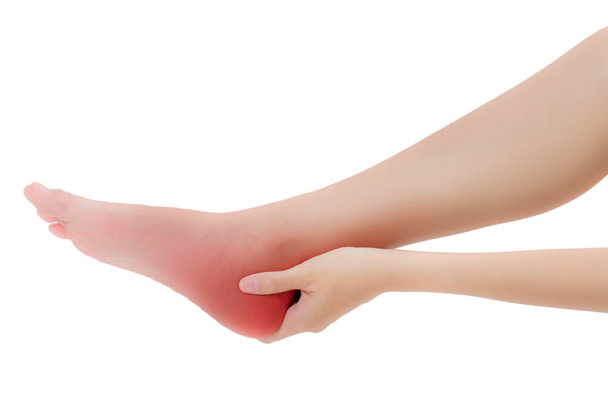 woman hand holding her beautiful healthy foot and massaging ankle hamstring in pain area with red highlighted, Isolated on white background. - Foto, Imagem