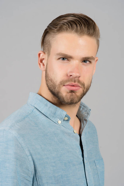 Bearded man in blue shirt. Man with beard on unshaven face skin. Skincare and hair care in beauty salon. Fashion or style and trend. Confidence and charisma. - Fotó, kép