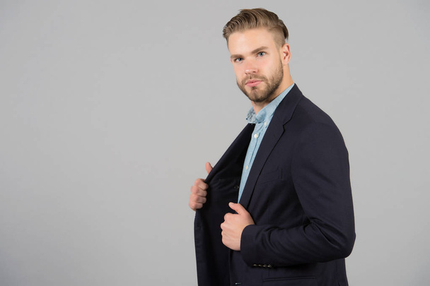 Businessman with stylish hair in formal suit. Man with beard and mustache on unshaven face. Beard grooming and hair care in barbershop. Business fashion or style and trend concept, copy space. - Photo, Image